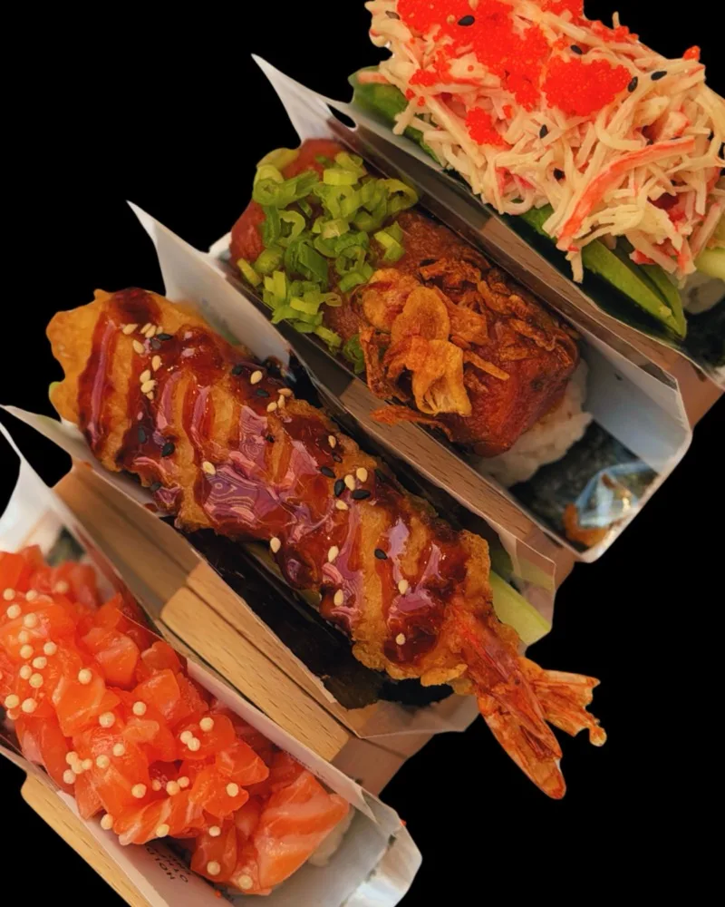Hand rolls in paper holders, stacked and ready to serve